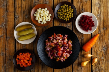 Traditional Russian dish vinaigrette. Vegetarian salad of beets, potatoes, carrots, pickles, green peas and onions. Healthy eating concept.