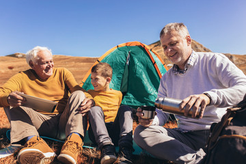 Three generations of family camping together in the autumn.