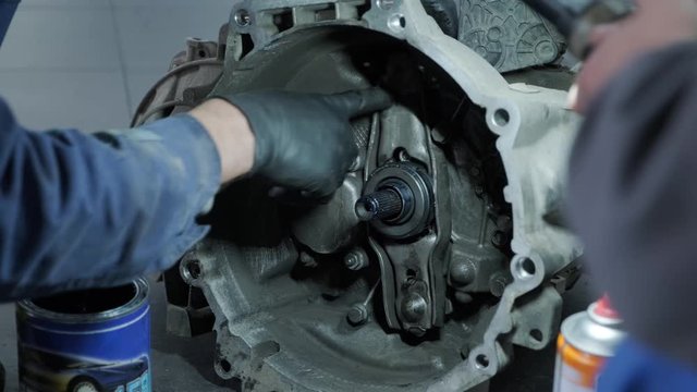 Change and repair clutch, drive axle. working underneath a lifted car