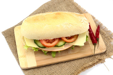 chicken and raw vegetable sandwich on a white background