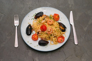 Spaghetti pasta with shrimp, mussels, tomatoes and cheese. Tasty, traditional Italian food