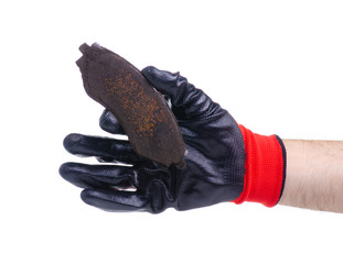 old rusty brake pads for cars in hand on white background isolation © Kabardins photo