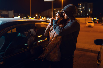 Female driver and hijacker at the car, robber