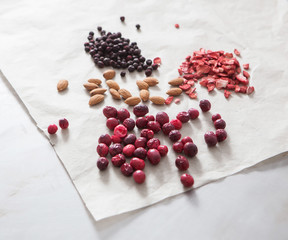 Mixed nuts and raisins. Healthy food and snacks. Almonds, raspberries, cranberries.