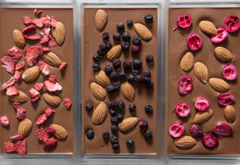 making chocolate with berries at confectionery shop kitchen