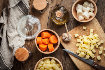 Diced potatoes on a wooden chopping board.