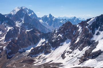 Wild snowy mountain range. Mountains landscape. Climbing in highlands. View from Chimtarga peak in Fann mountains, Tajikistan