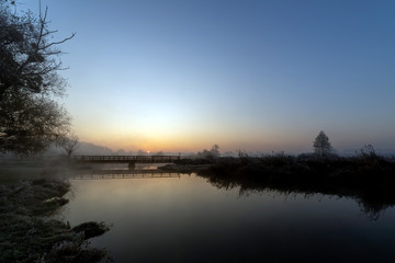 Fototapeta premium A beautiful sunrise over the misty river.