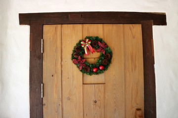 Wreath stuck on a wooden door.