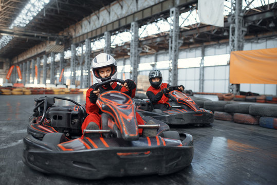 Two kart racers enters the turn, front view