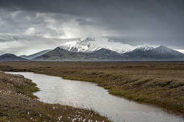 water and mountain landscape on a rainy day in Laugarfell Highland in Iceland