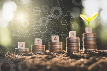 Five rows of stacked coins are on the loam and have technology icons about financial growth around....