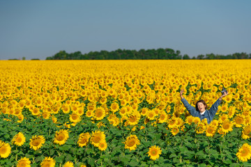 Naklejka premium Happy girl on Sunflower field in Russia, Summer, Vacation