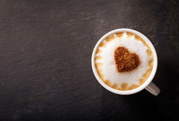Valentines day.  Cup of cappuccino coffee with drawn heart, top view