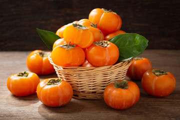 Fototapeta na wymiar fresh ripe persimmon fruit in a basket