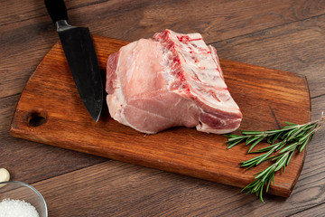 Fresh steak loin of raw meat and spices and a knife lies on a wooden background. copy space