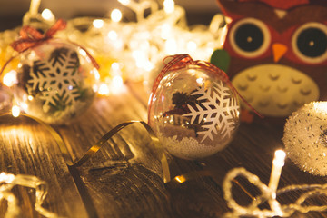 Vintage Christmas background with christmas baubles on wooden background over christmas lights