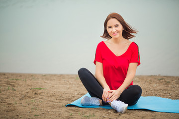 beautiful adult woman in sportswear goes in for sports outdoors in summer