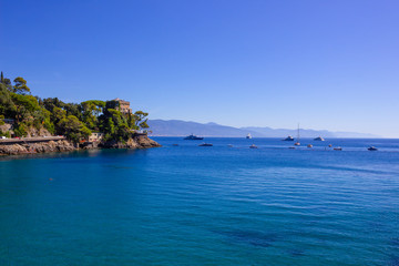 Fototapeta na wymiar The beach near portofino in genoa on a blue sky and sea background