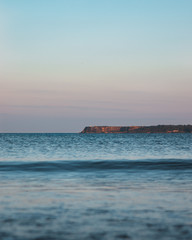 Wave approachinng the coast at sunset 