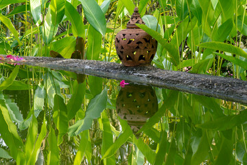 Terracotta lantern reflecting in water, Tha Ton, Thailand