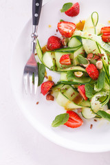 light summer detox salad with strawberries, cucumber, nuts and flax seeds