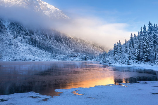 Winter sunrise over scenic frozen lake