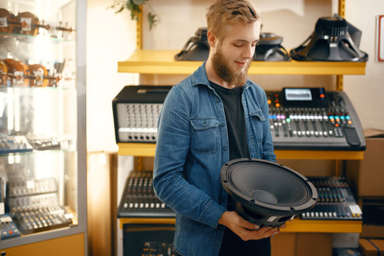 Musician buying subwoofer speaker in music store