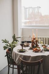 Table served for Christmas dinner in living room, close up view.