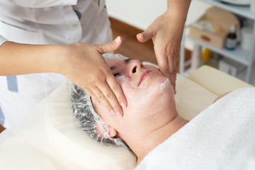 Obraz na płótnie Canvas Face massage. Close-up of woman getting spa massage treatment at beauty spa salon. Spa skin and body care. Facial beauty treatment. Cosmetology