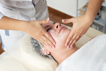 Obraz na płótnie Canvas Face massage. Close-up of woman getting spa massage treatment at beauty spa salon. Spa skin and body care. Facial beauty treatment. Cosmetology