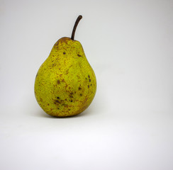 Organic green pear on a white background close-up