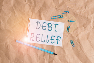 Writing note showing Debt Relief. Business concept for a reduction in the amount of debt that a country has to pay Papercraft desk square spiral notebook office study supplies