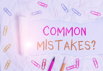 Conceptual hand writing showing Common Mistakes Question. Concept meaning repeat act or judgement misguided making something wrong Stationary and torn cardboard on a plain pastel table backdrop