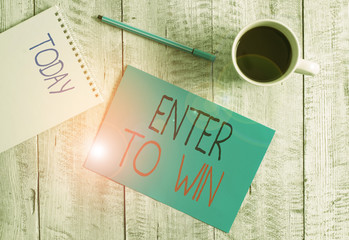 Writing note showing Enter To Win. Business concept for exchanging something value for prize or chance of winning Stationary placed next to a cup of black coffee above the wooden table