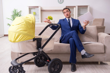 Young businessman looking after baby