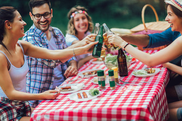 Group of friends enjoying a lunch time together in the nature.