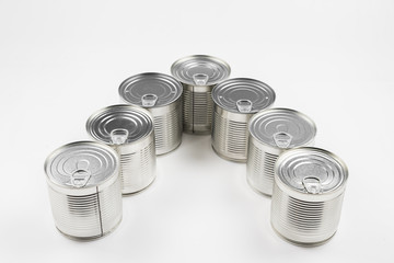 Group of silver canned food on white background.