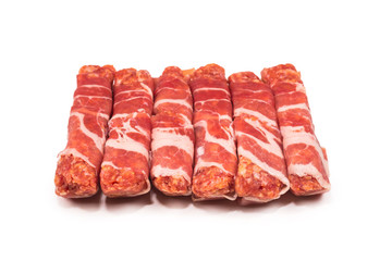 Chevapchichi in bacon isolated on white background.