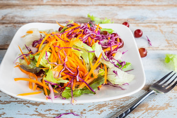 Bowl of vegetable salad on wooden table