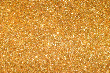 shine and sparkle of golden glitter abstract background	