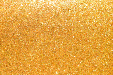 shine and sparkle of golden glitter abstract background	