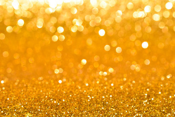 shine and sparkle of golden glitter abstract background	