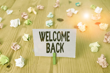 Writing note showing Welcome Back. Business concept for something back to greet the return of someone or something Colored crumpled papers wooden floor background clothespin