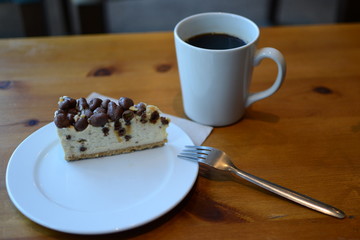 A Delicious Cheesecake And Black Coffee