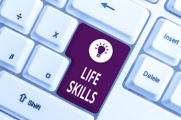 Conceptual hand writing showing Life Skills. Concept meaning skill that is necessary for full participation in everyday life White pc keyboard with note paper above the white background