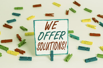 Handwriting text We Offer Solutions. Conceptual photo way to solve problem or deal with difficult situation Colored clothespin papers empty reminder white floor background office