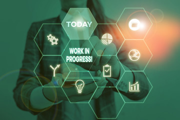 Handwriting text Work In Progress. Conceptual photo unfinished project that still added to or developed Woman wear formal work suit present presentation using smart latest device