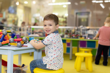 Children play with educational toys. Children sit on the carpet in the playroom at home or in the kindergarten.boy with toy cars