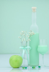 Pistachio liqueur with apple and lollipops